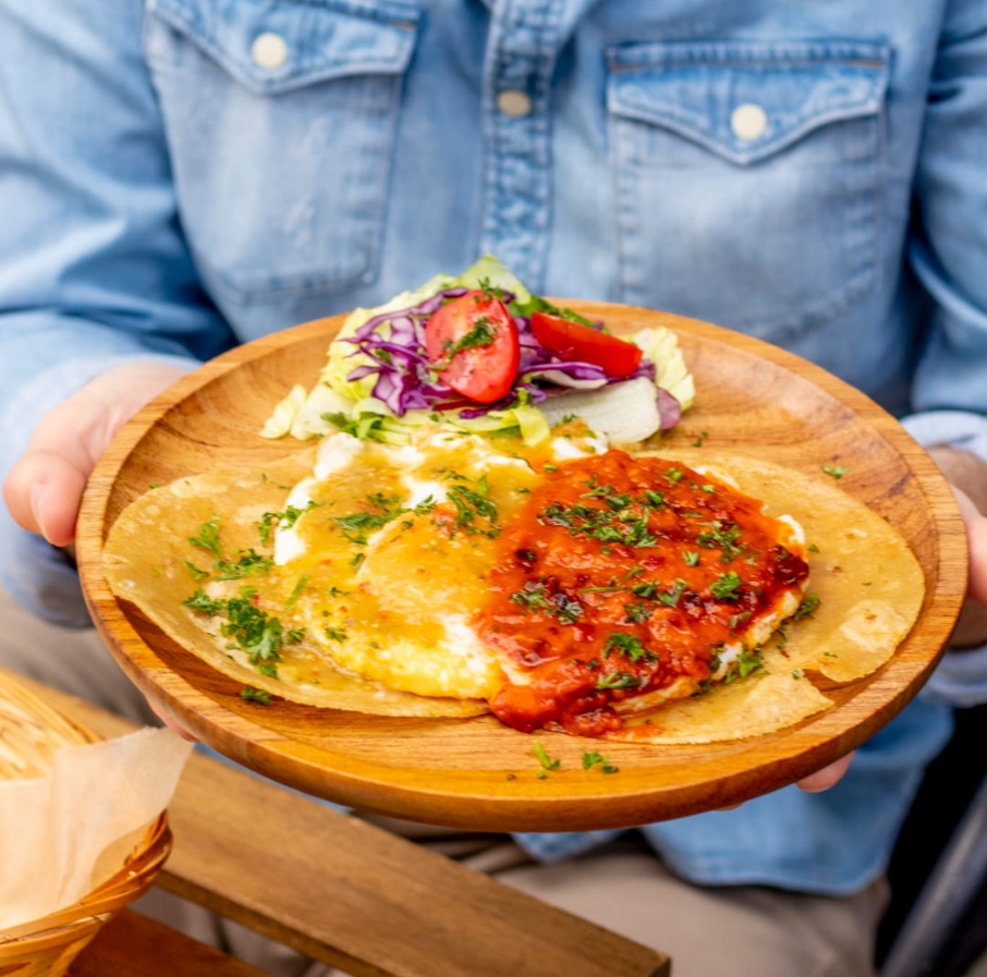 Plate of eggs with sauce and salad